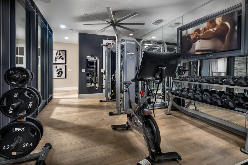 home gym with bike and fan